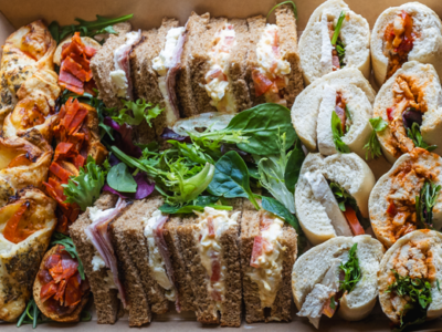 Image of gourmet sandwiches, canapes ,cakes and fruit