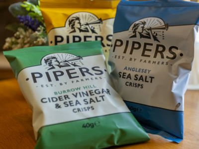 Image of 3 packets of Pipers crisps on a table