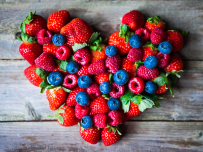 Image of fruit arranged in heart shape, blueberries, strawberries and raspberries